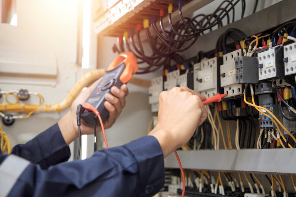 An electrician working on a panel